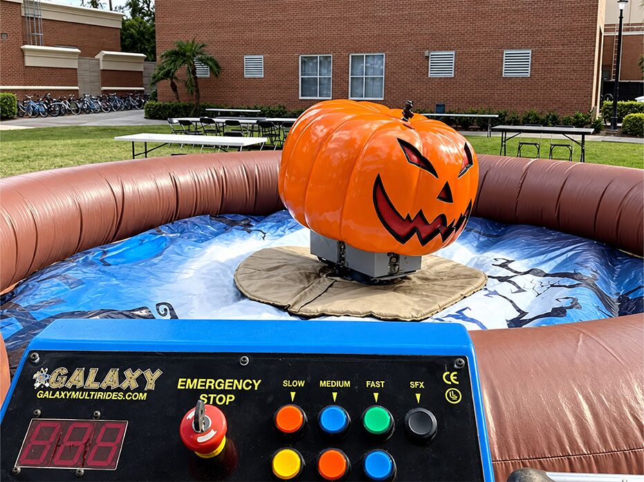 Mechanical Pumpkin ride: a jack-o'-lantern on a mechanical base inside an inflatable ring